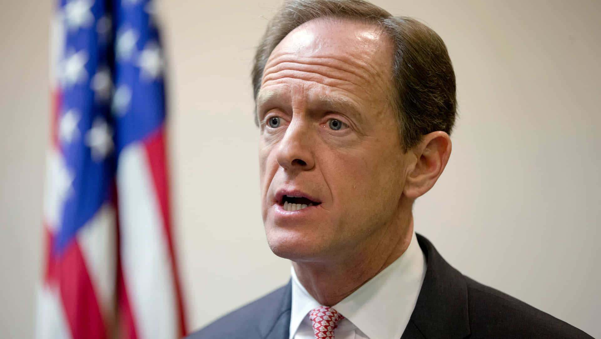 Pat Toomey Delivering A Powerful Speech Under Spotlight.