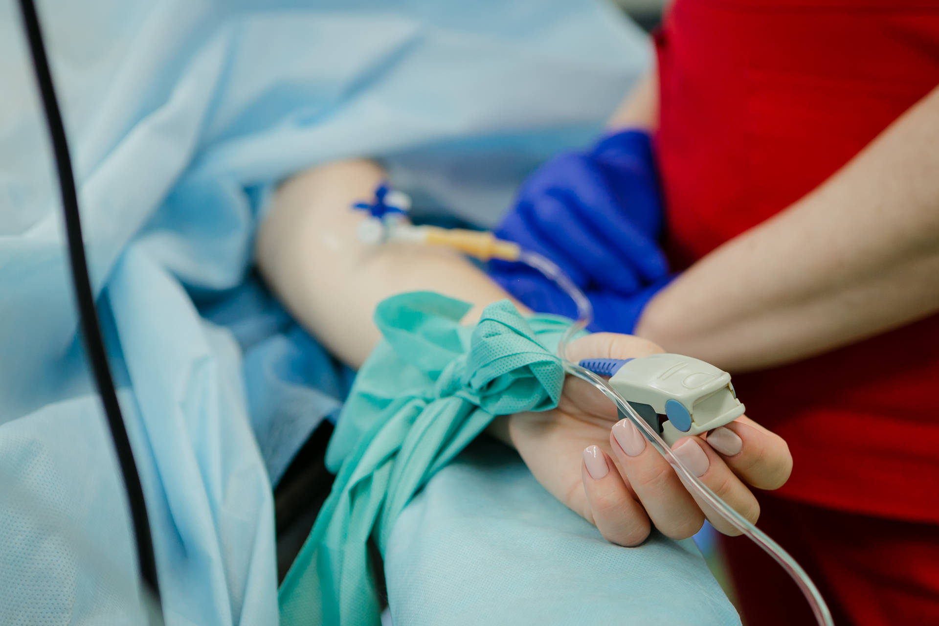 Patient Receiving Iv Drip Treatment In A Hospital Background