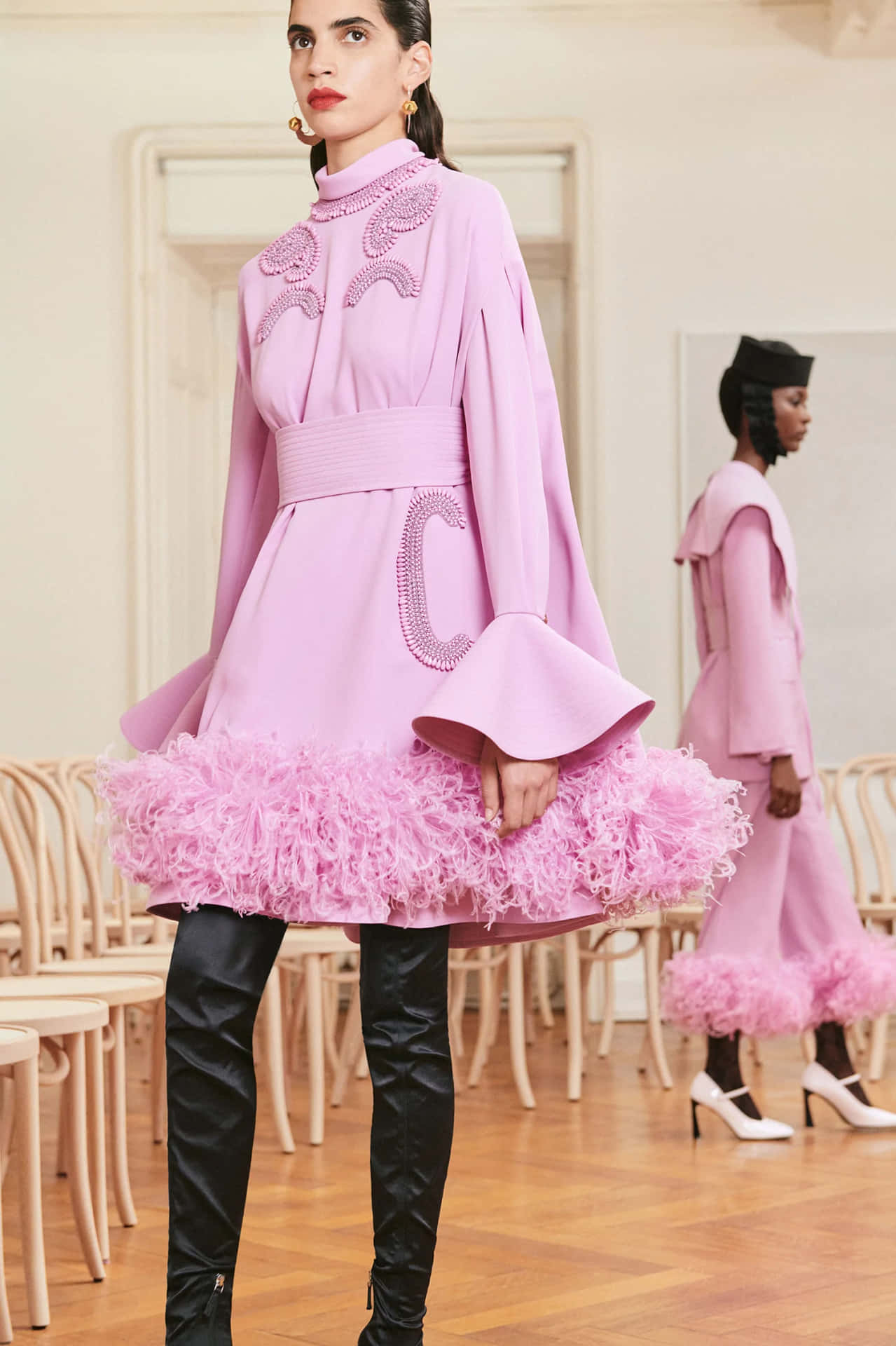 Patou's Pink Feather Cape Dress In A Stunning Pose Background