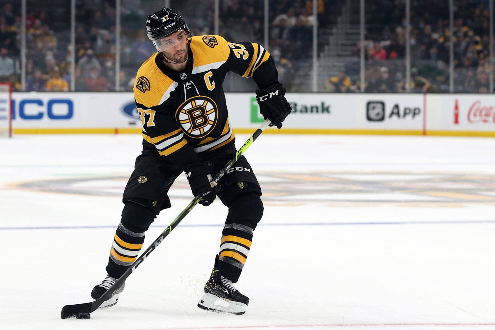 Patrice Bergeron In Action On Ice Hockey Background