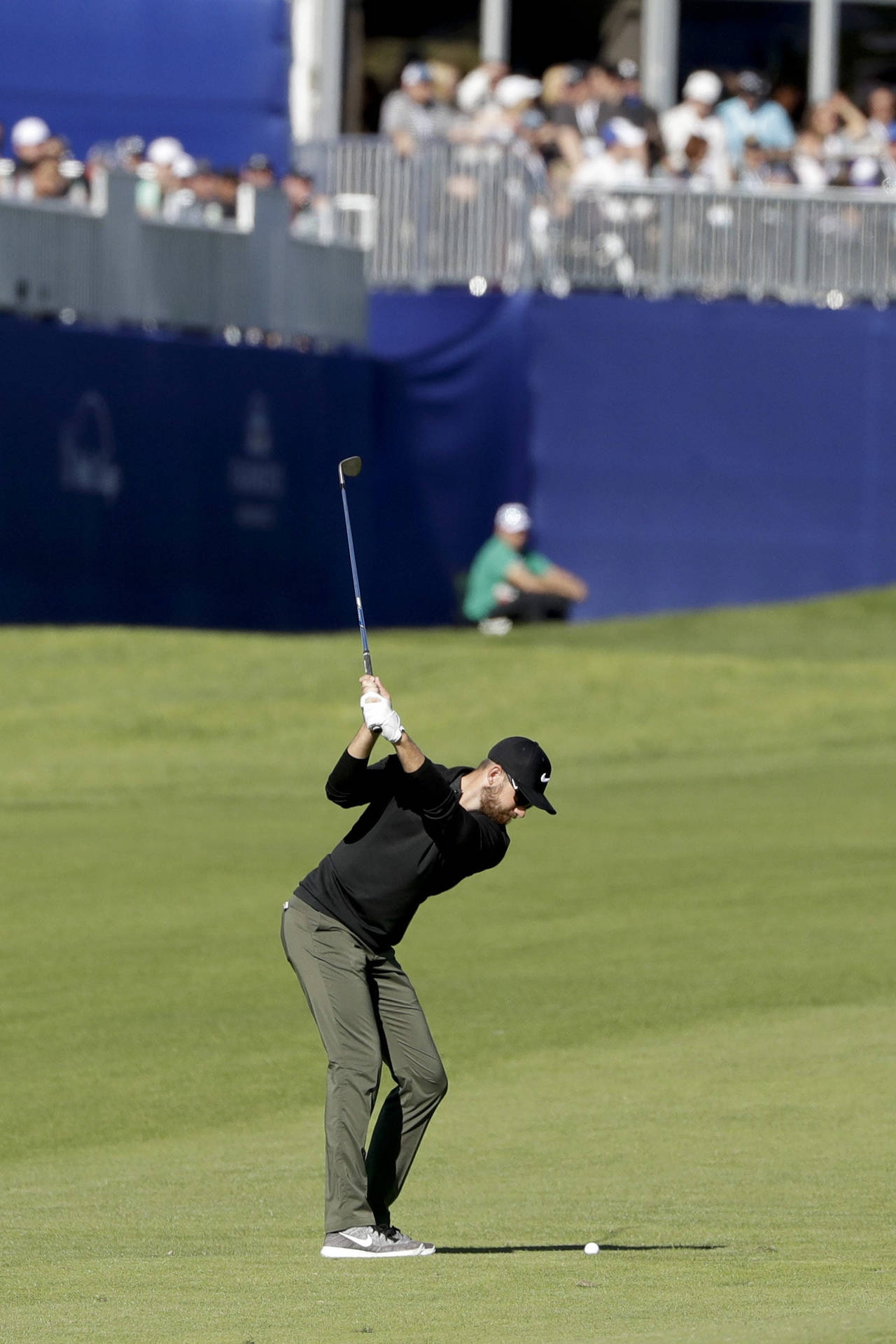 Patrick Rodgers In Mid-swing On Golf Course Background