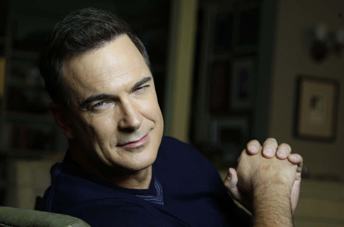 Patrick Warburton Looking Intense In Blue Shirt Background