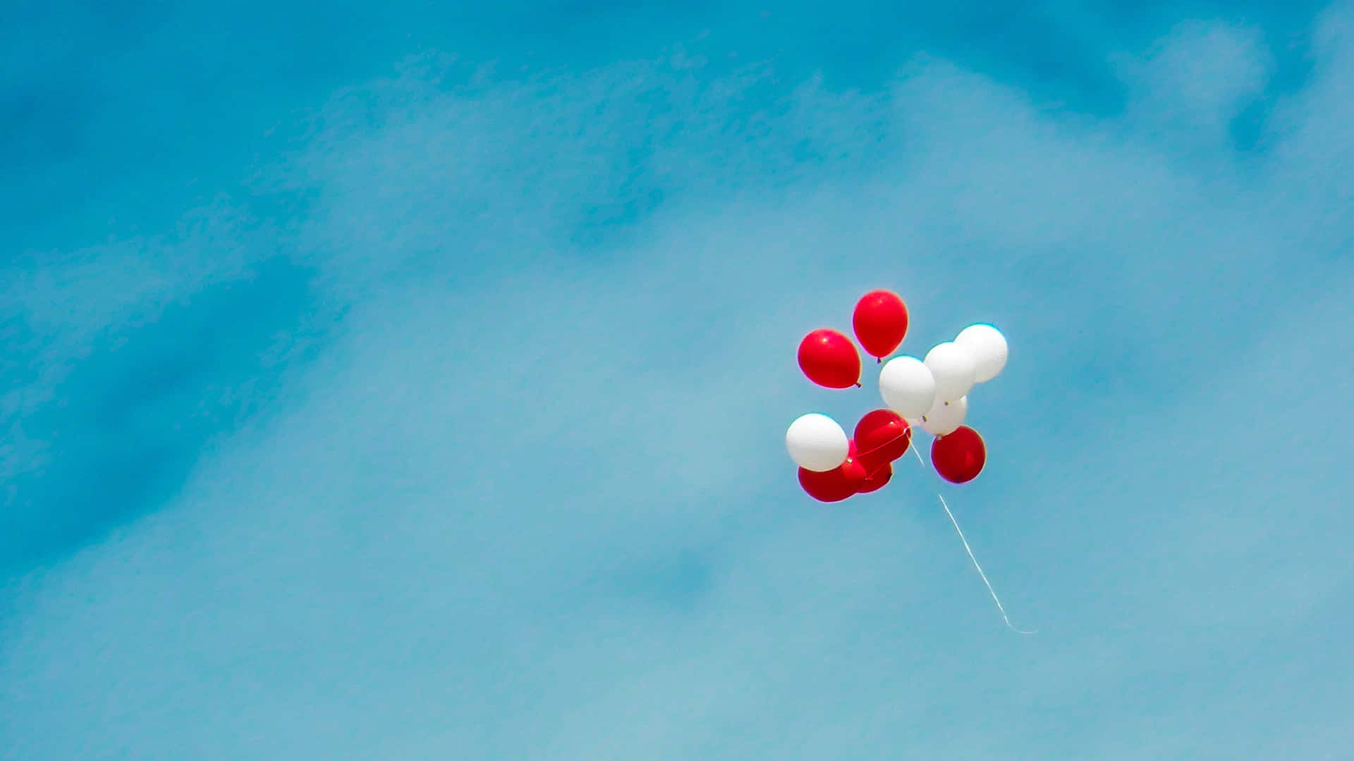 Patriotic Balloons Against Blue Sky Background