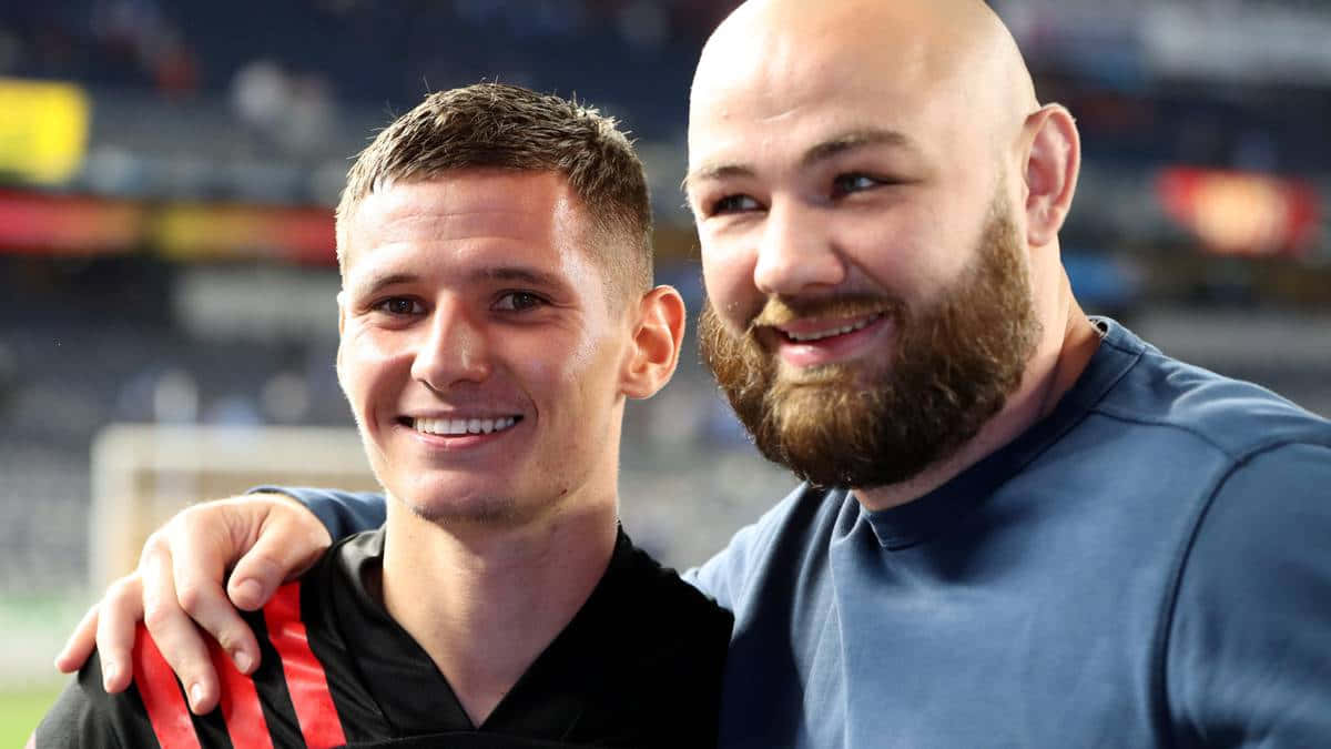 Patryk Klimala Smilingwith Fan Background