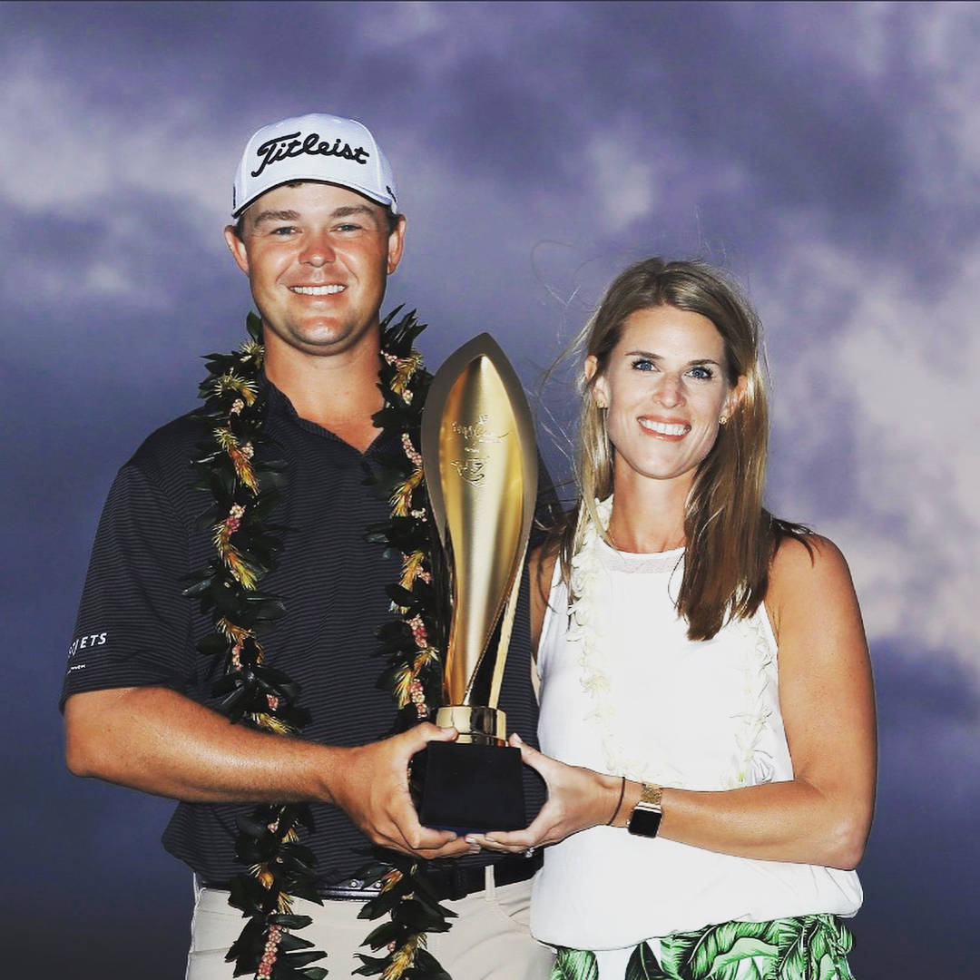 Patton Kizzire Holding Trophy Background