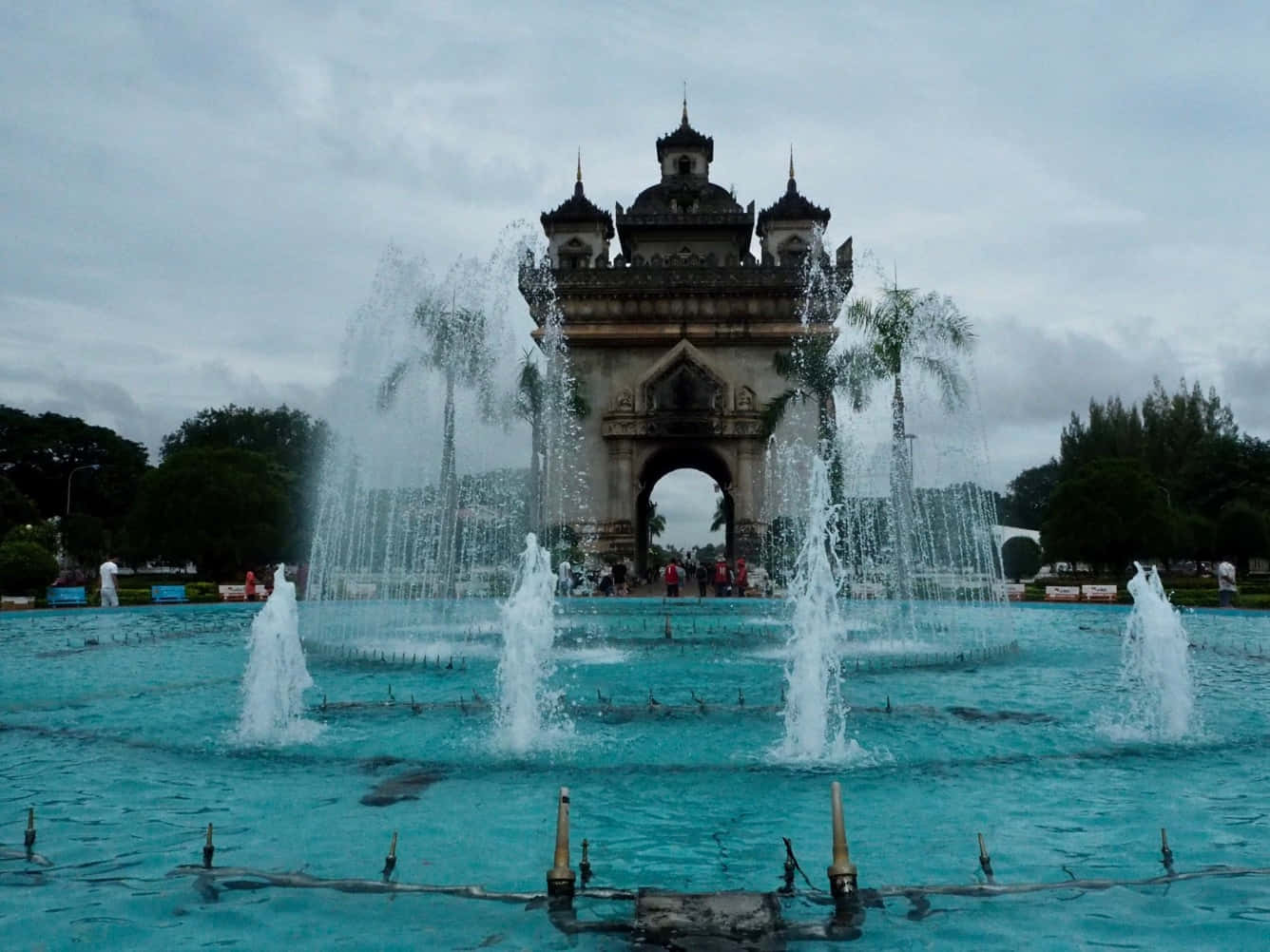 Patuxai Monument With Blue Fountain Background
