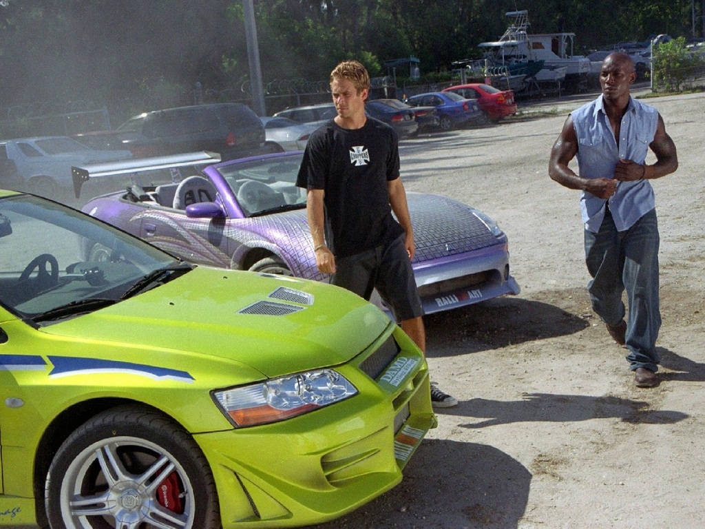 Paul Walker Behind The Wheel Of His Favorite Race Car Background