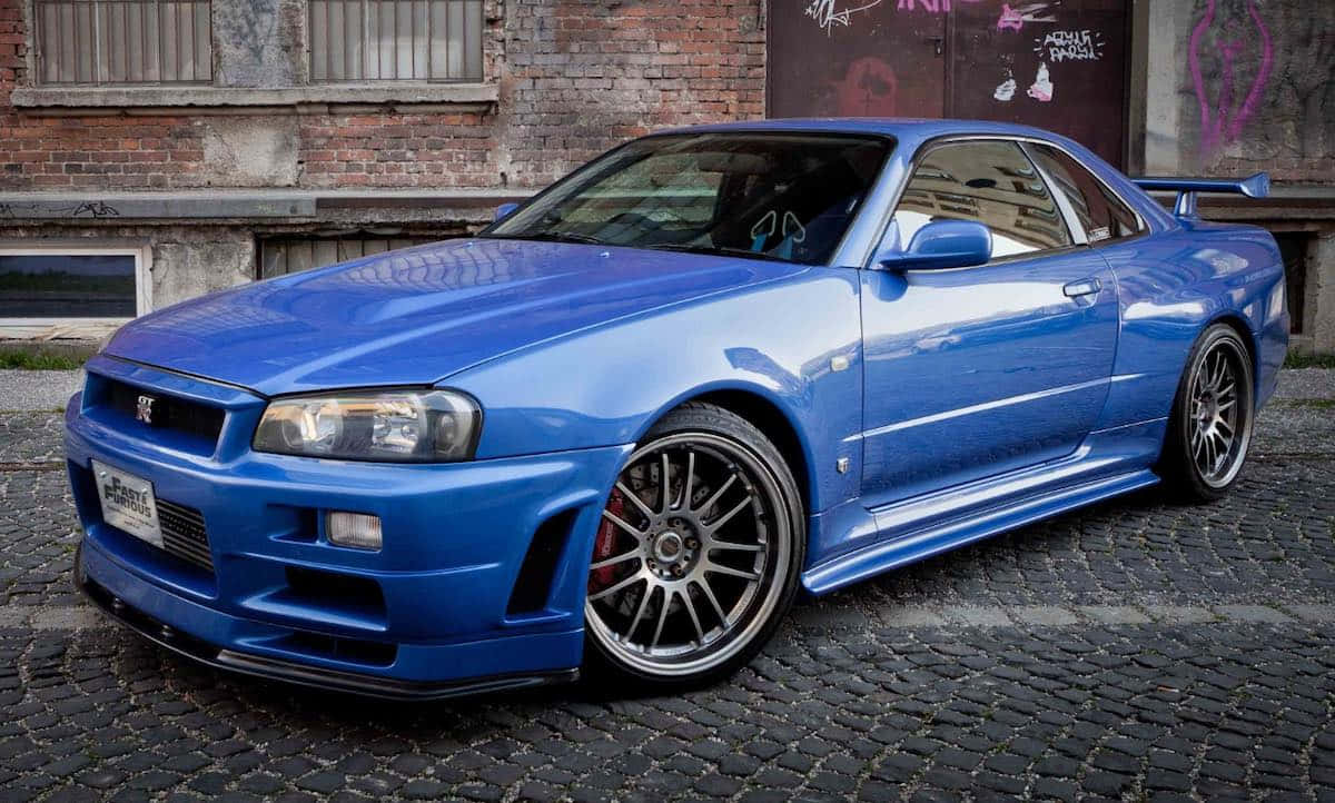 Paul Walker Driving Nissan Skyline In Street Race Background