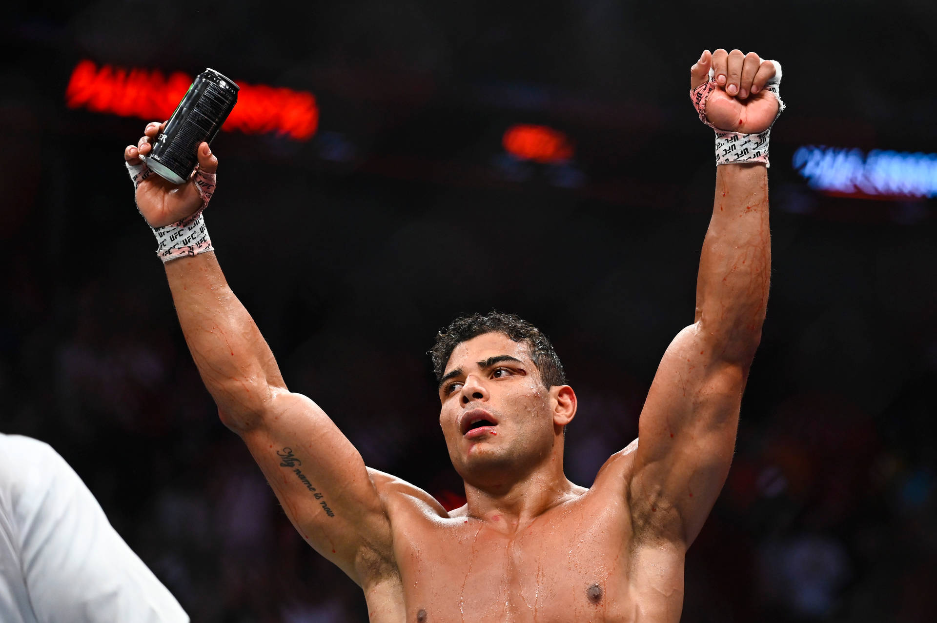 Paulo Costa Raising Hands In Victory Background