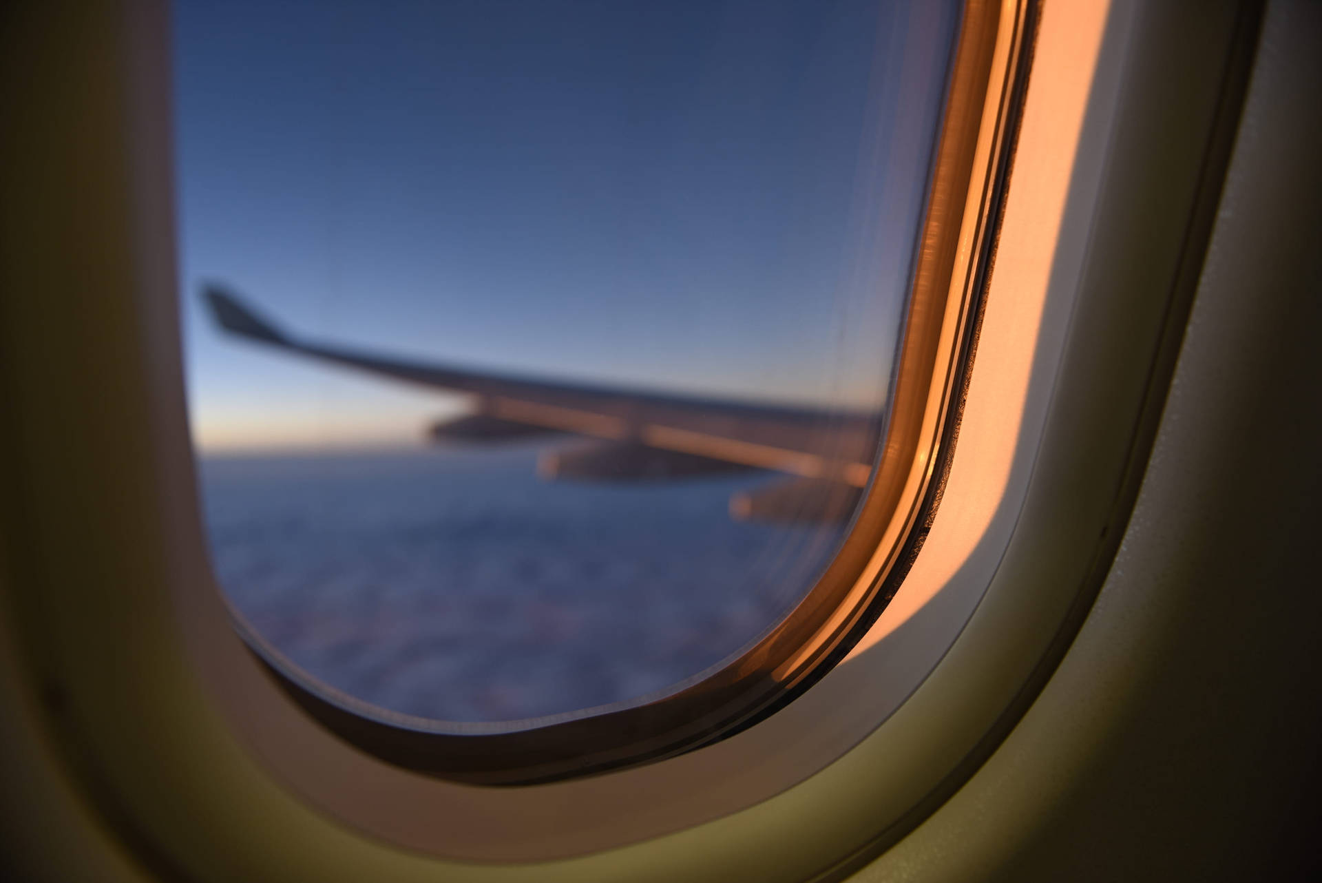 Peek Of The Airplane's Wing From A Plane Window