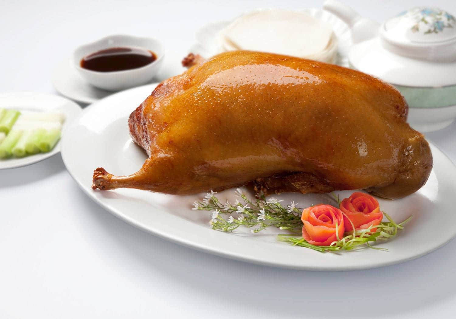 Peking Duck Centerpiece Near White Ceramics Background