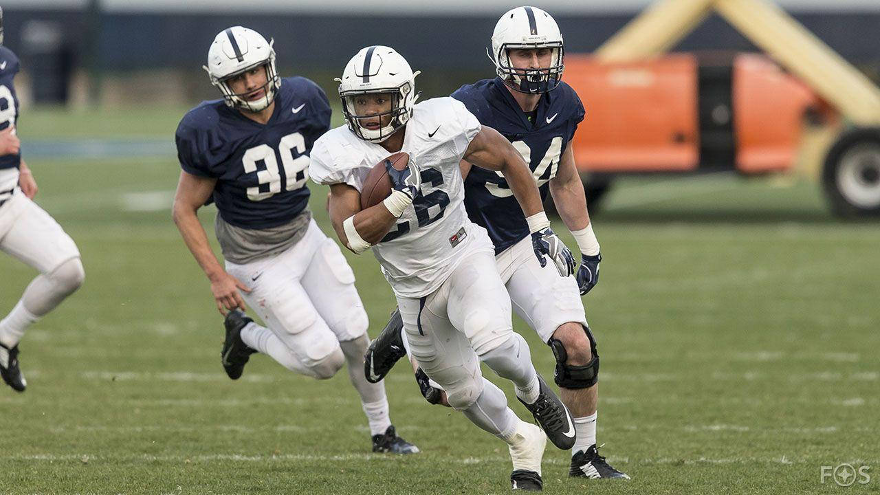 Penn State Football Players Running With The Ball Background