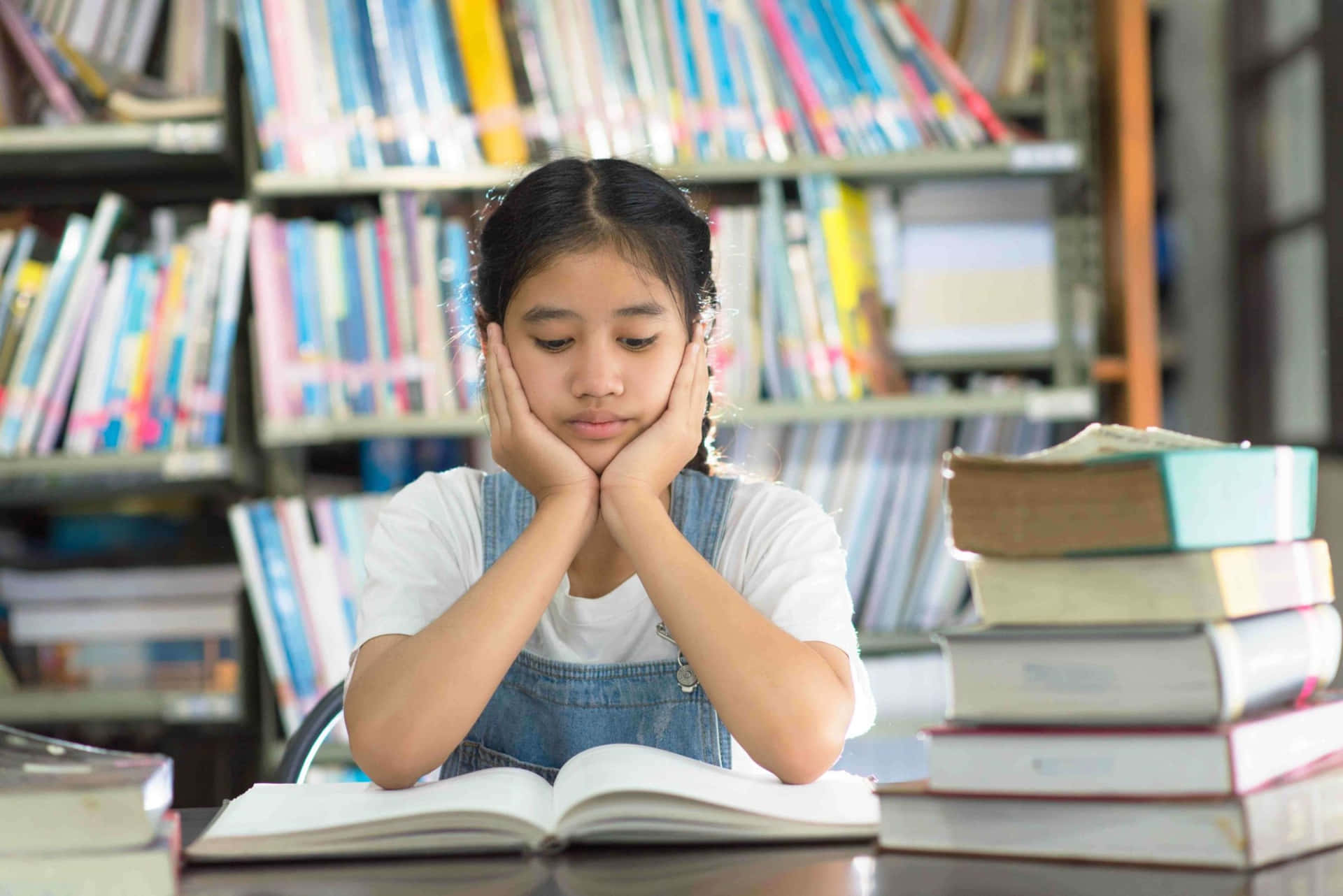 Pensive Young Girl In Library Background