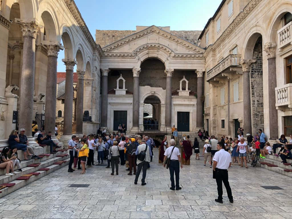 People At The Diocletians Palace Background