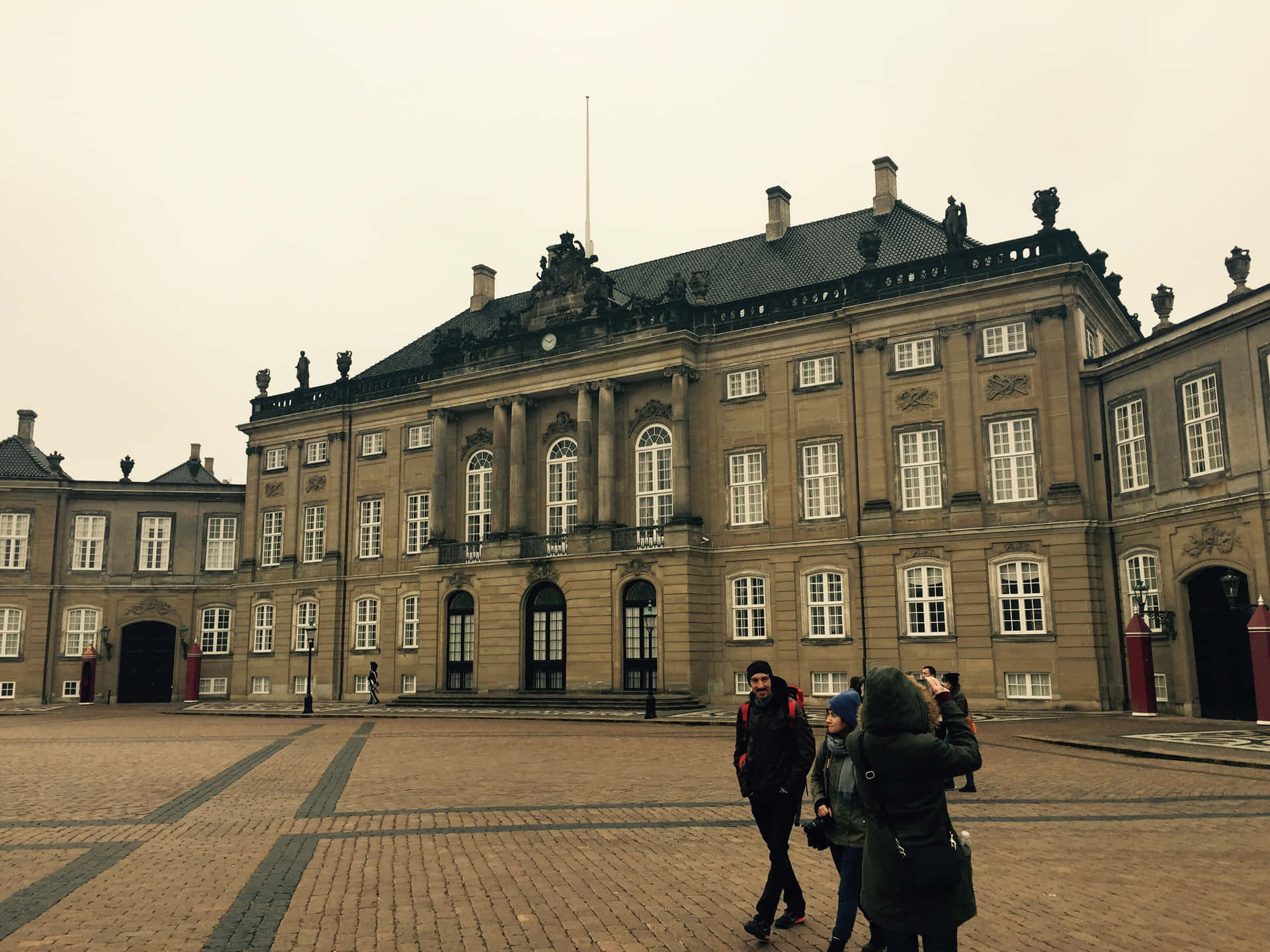 People In Amalienborg Palace Background