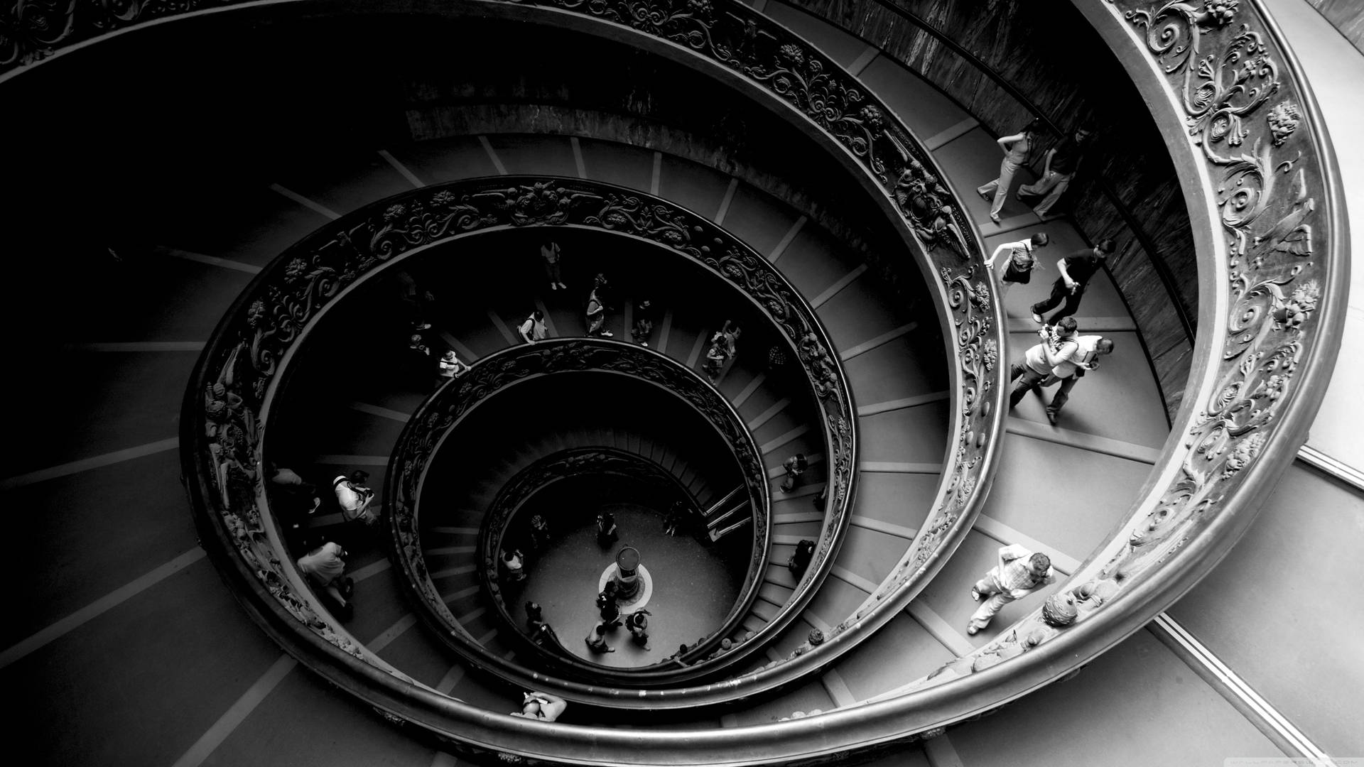 People In Spiral Staircase Background