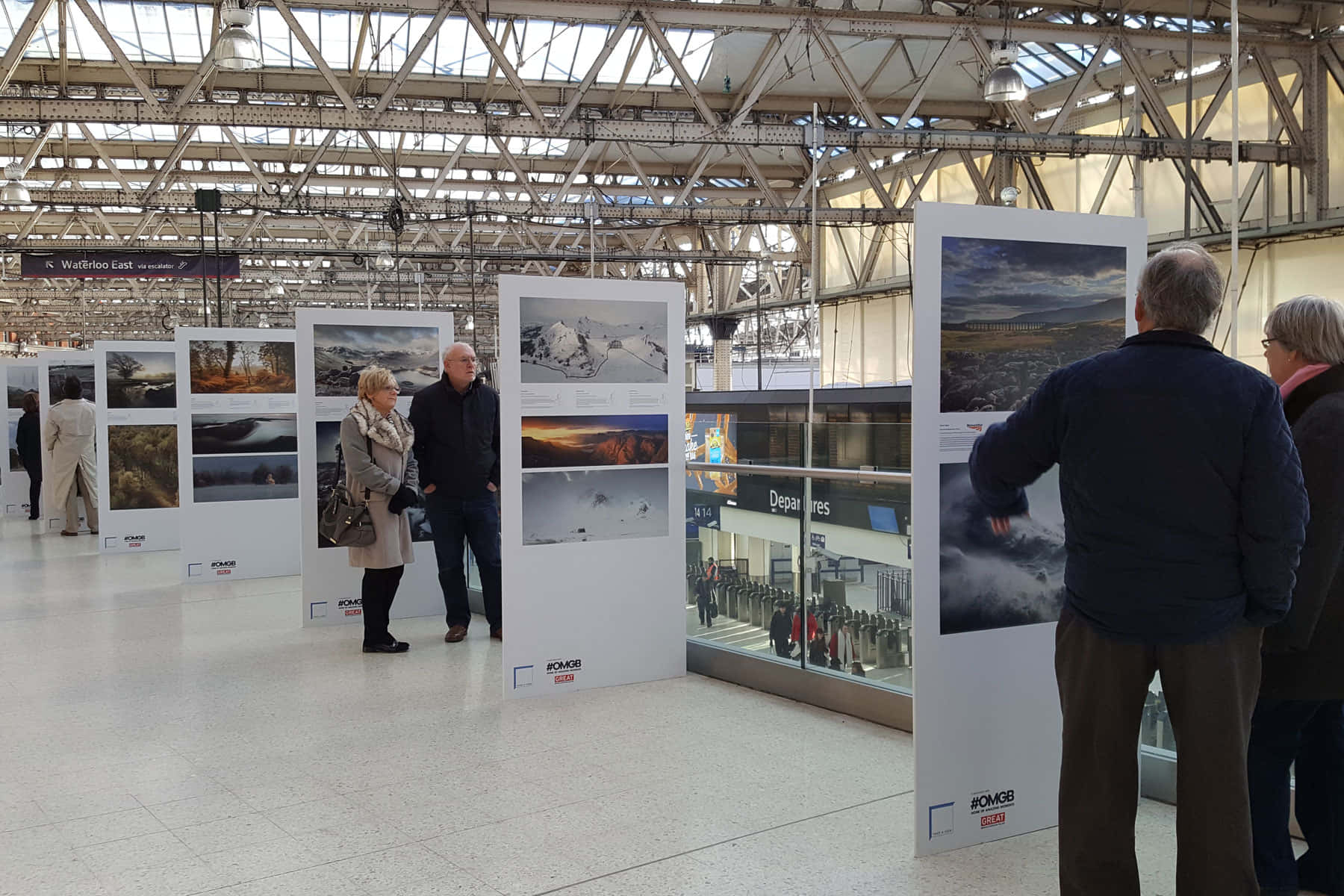 People Looking At Waterloo Station Exhibit Background