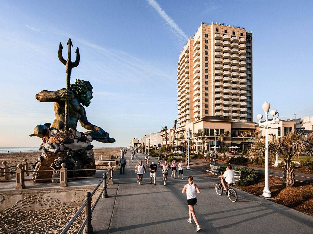 People Passing By Virginia Beach Statue Background