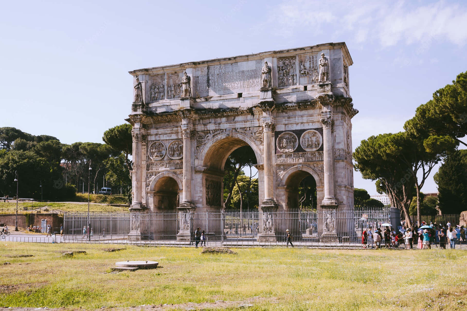 People Visiting Arch Of Constantine Background