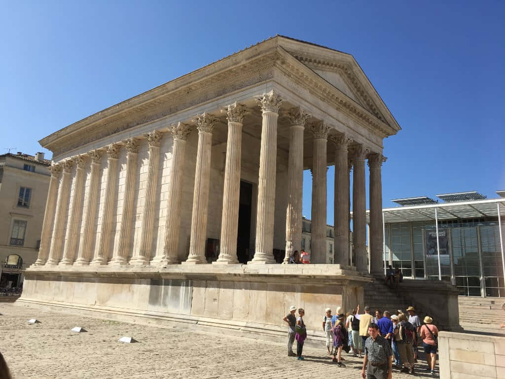 People Visiting The Maison Carrée Background