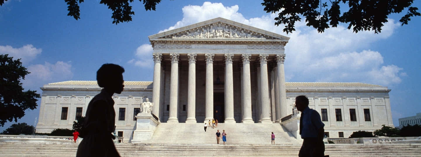 People Walking By The Supreme Court Building