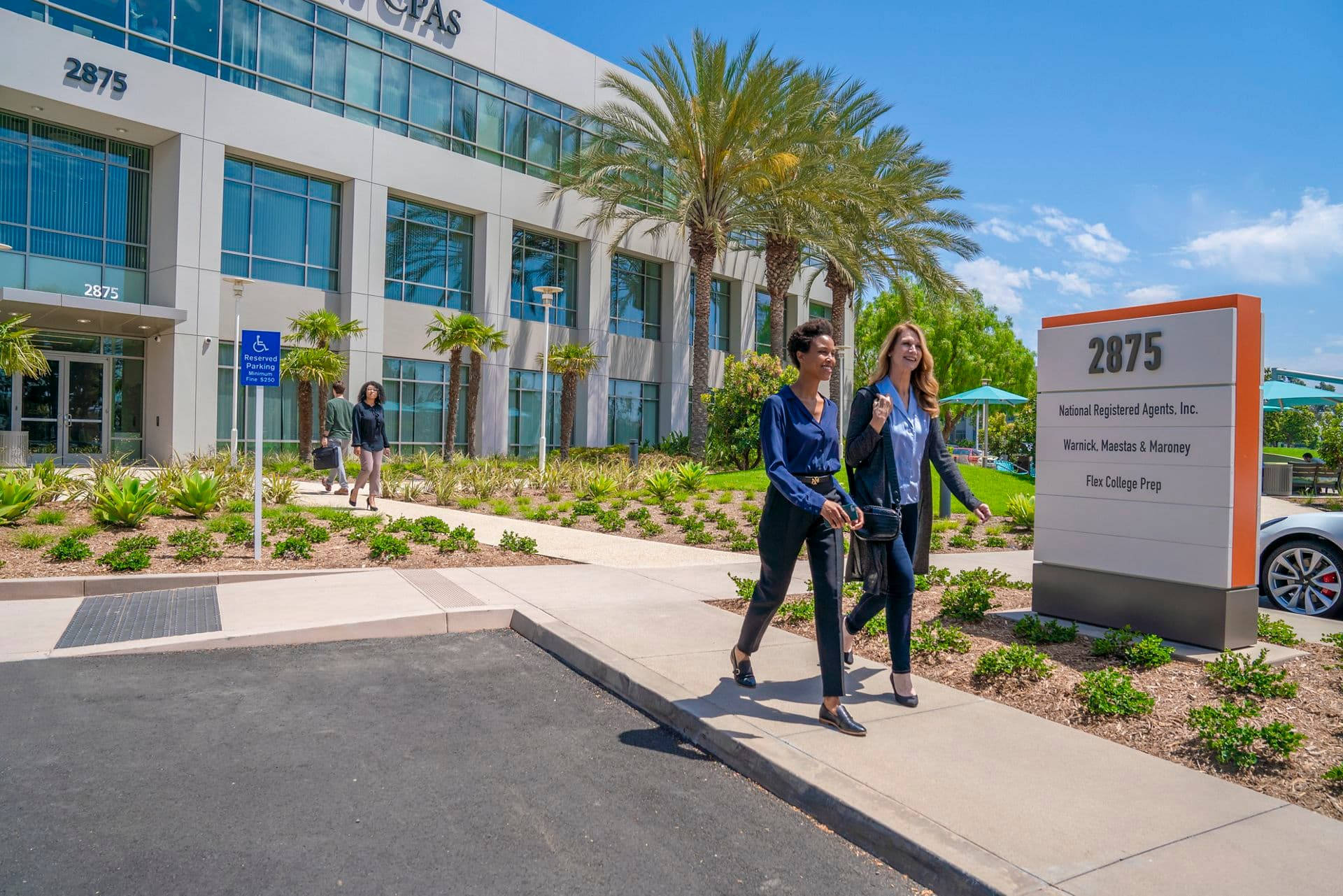 People Walking In Irvine Business Center Background