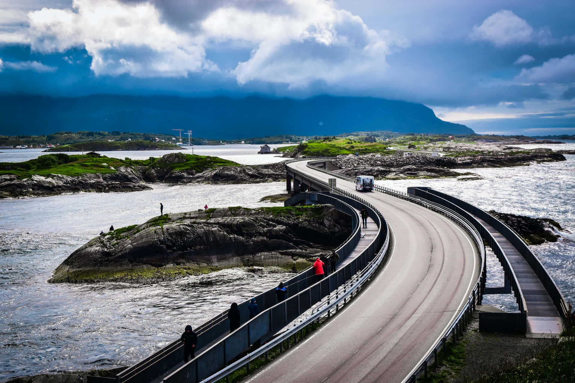 People Walking On The Storseisundet Bridge Background