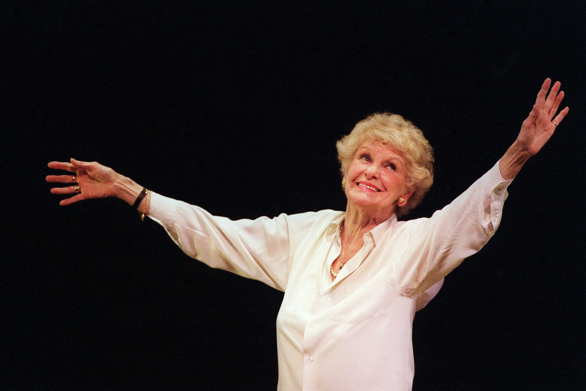 Performer Elaine Stritch Dancing On Stage Background