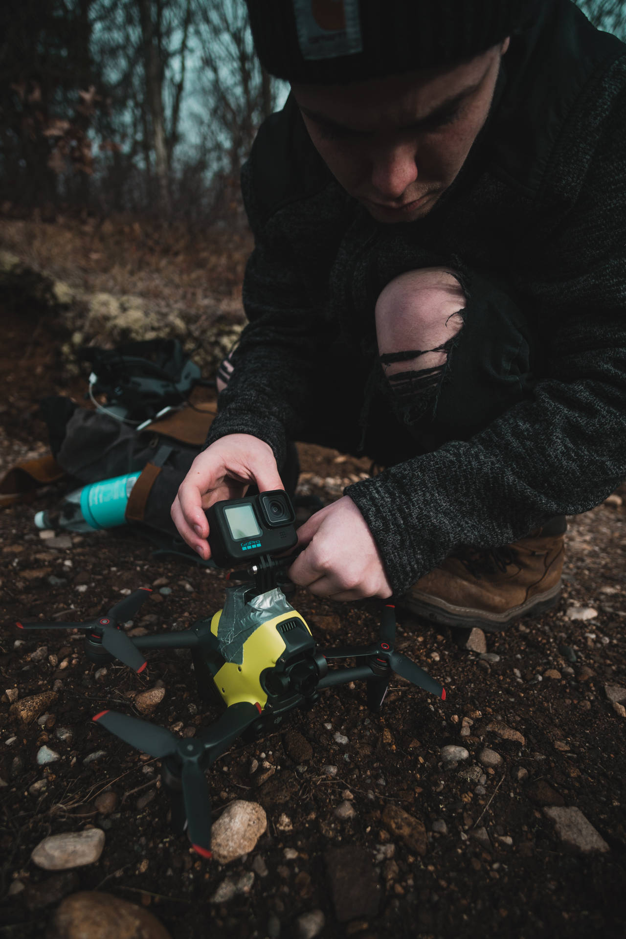 Person Attaching A Gopro To A Drone Background