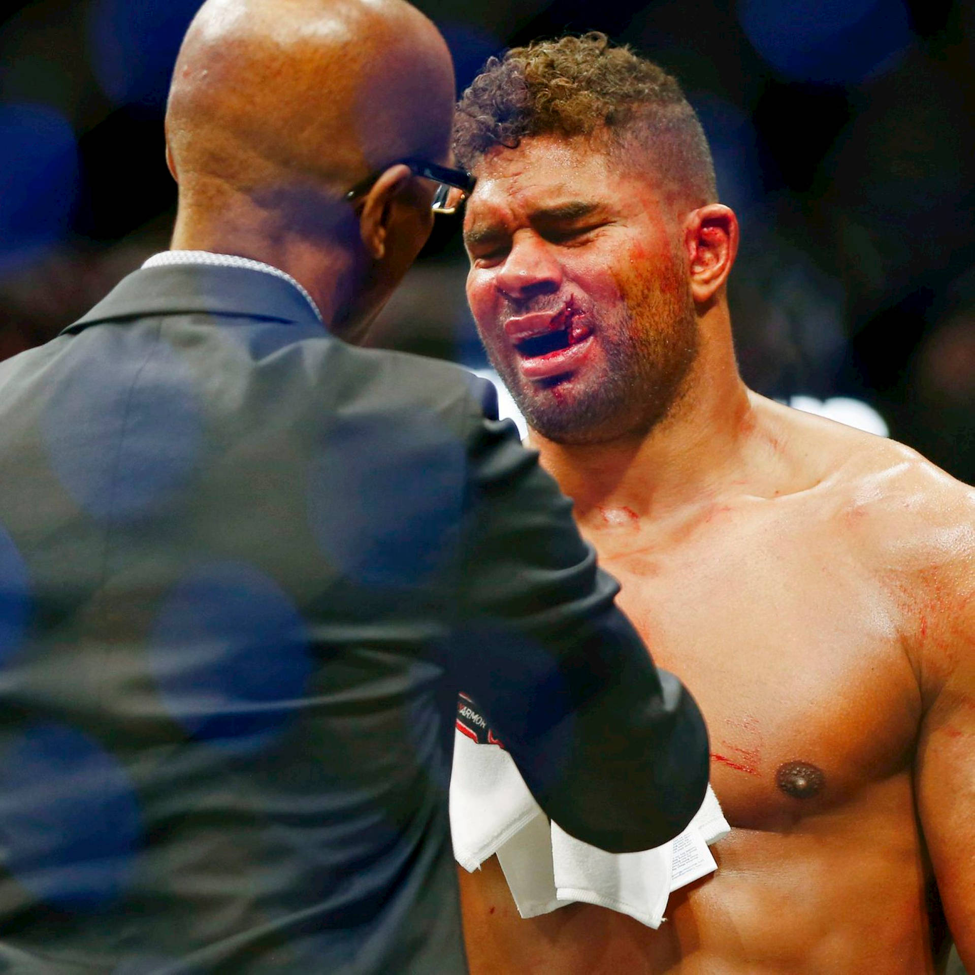 Person Checking Alistair Overeem Face Injury Background