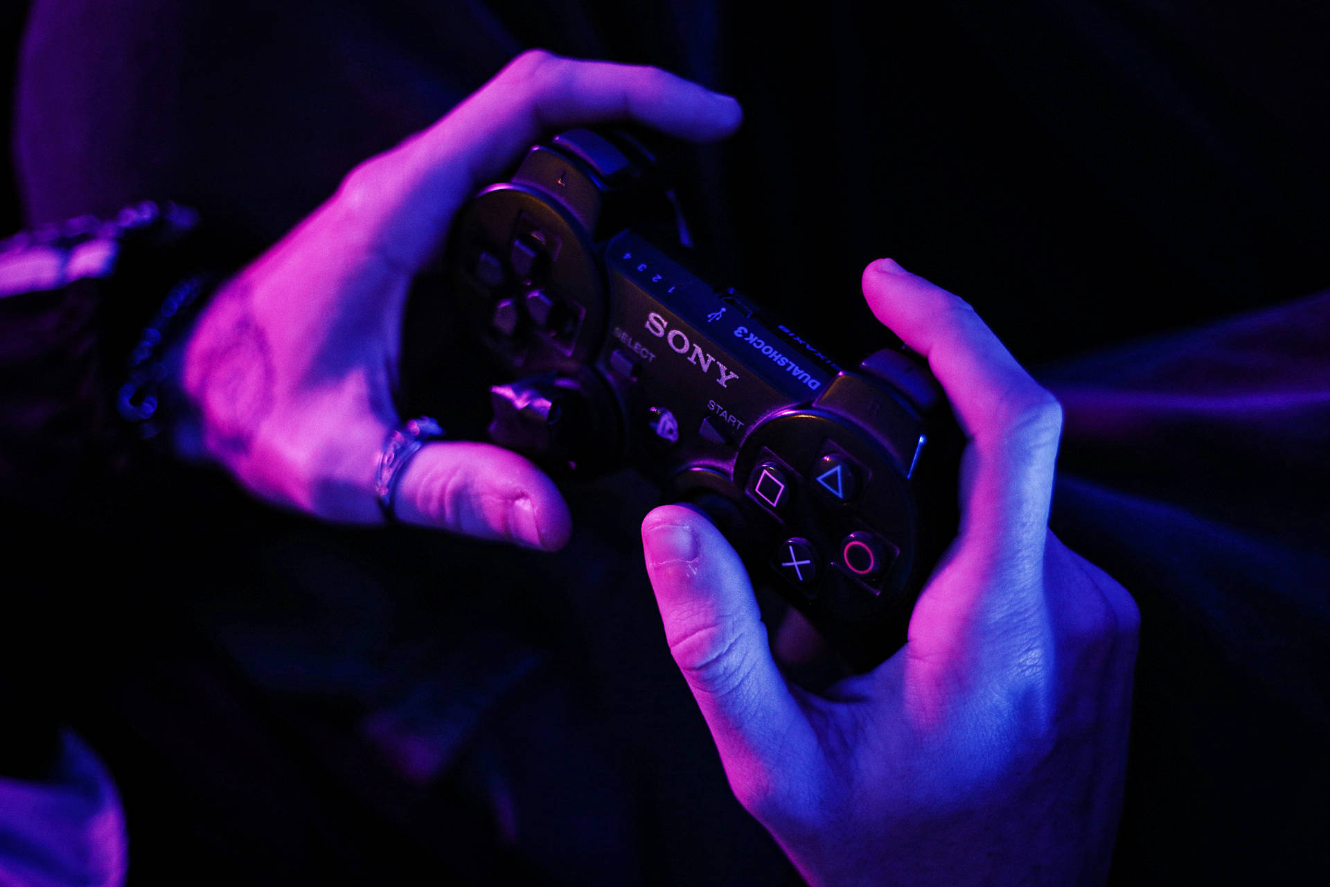 Person Holding Ps3 Controller Background