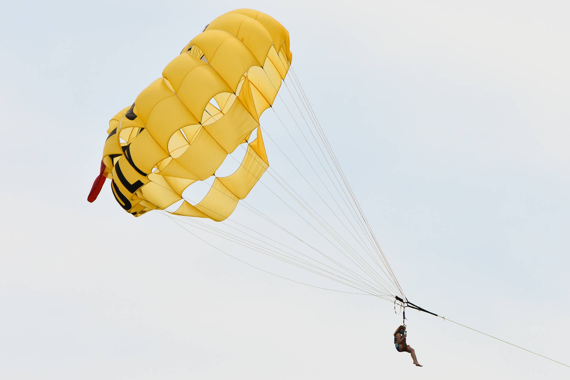 Person Parasailing In The Sky Background