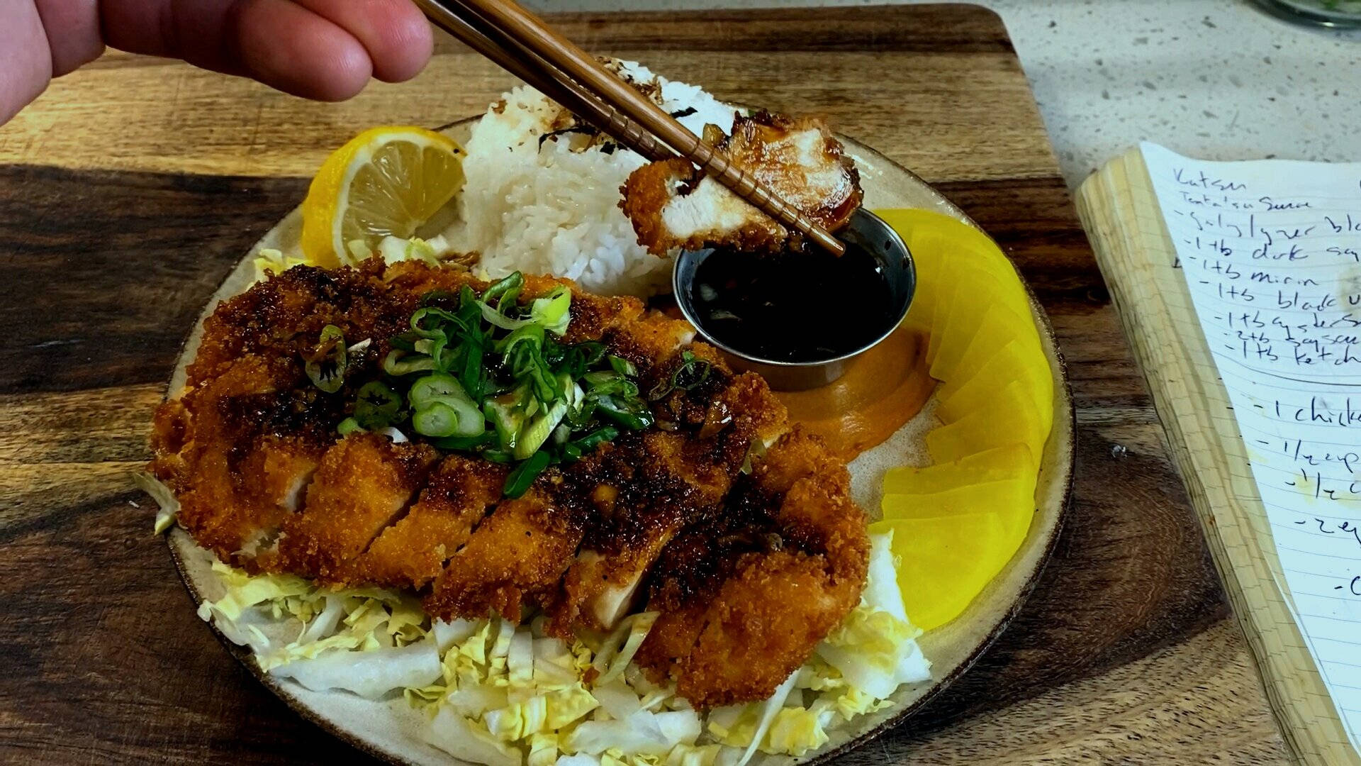 Person's Hand Pinching A Tonkatsu Using Chopsticks