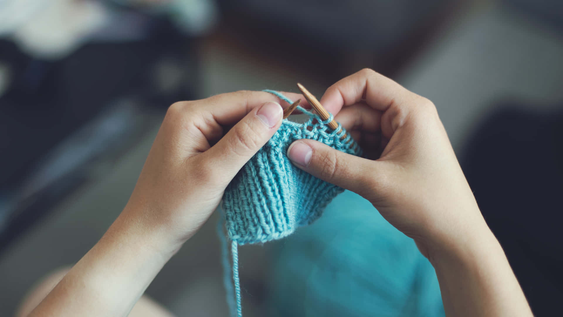 Person's Hands Knitting Blue Wool Yarn