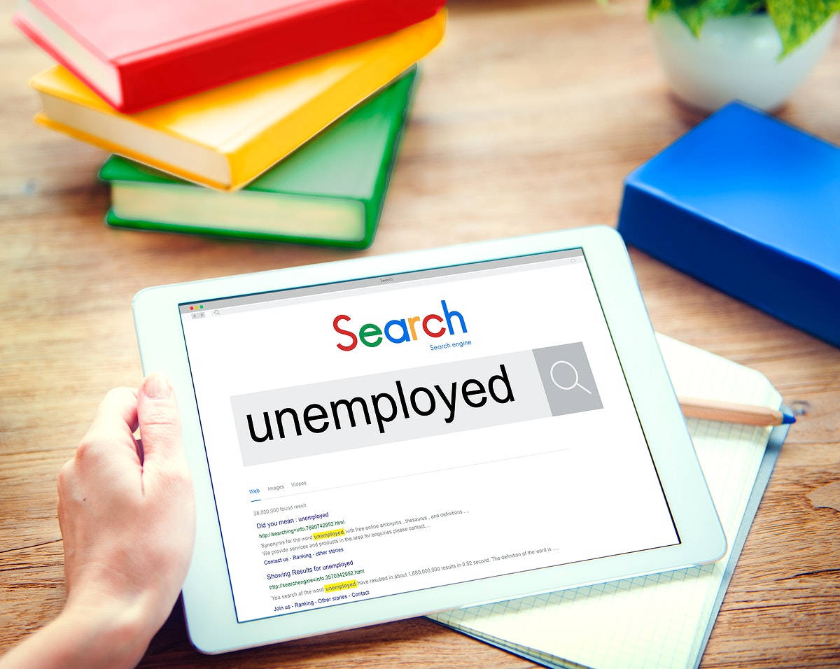 Person Searching For Unemployment Using A Tablet Background