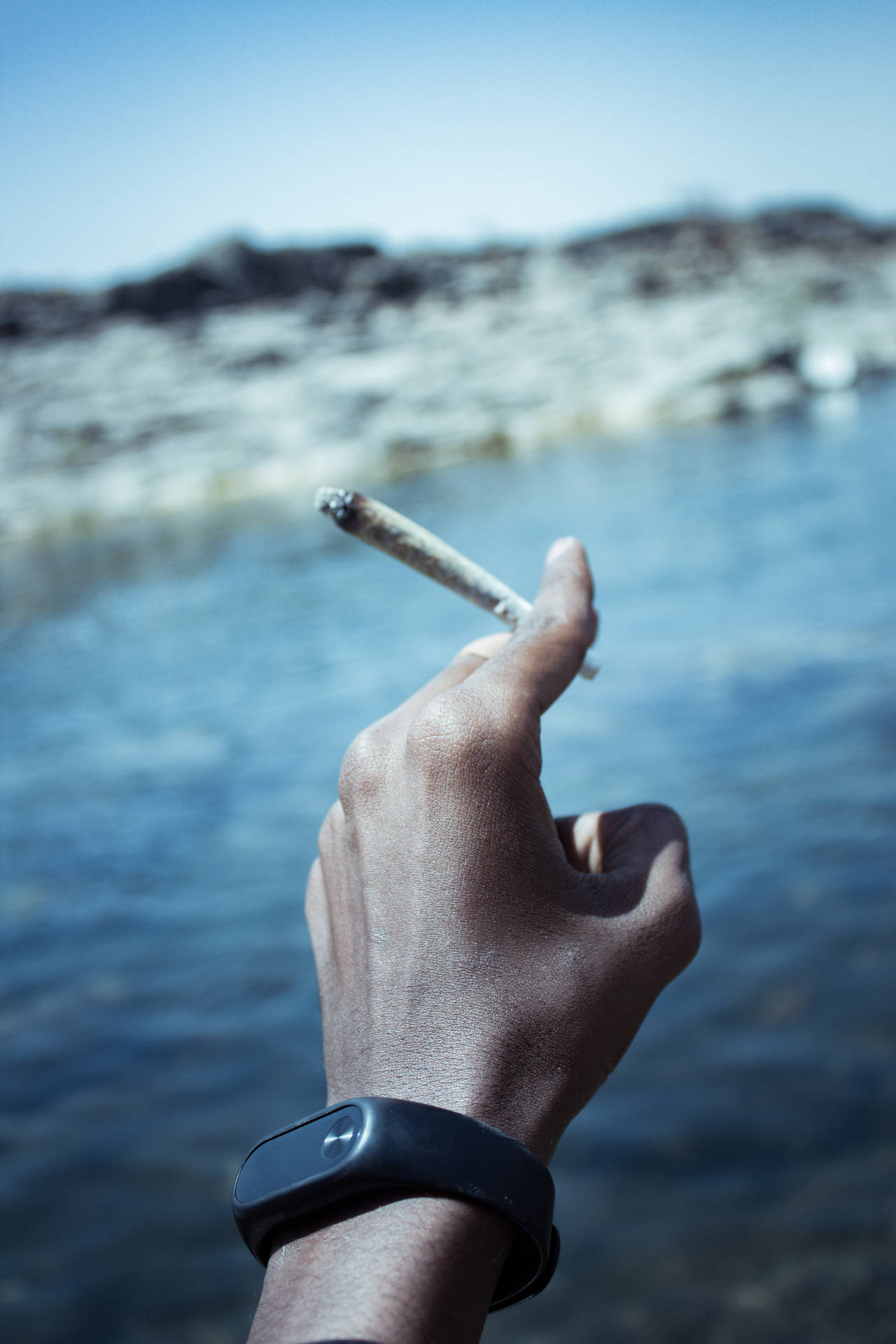 Person Smoking In Sea Background