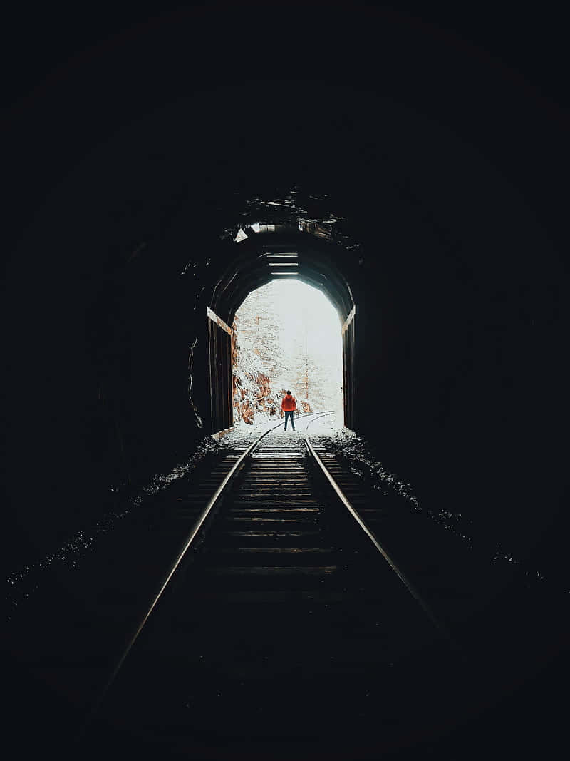 Person Walking Outof Dark Tunnel Background