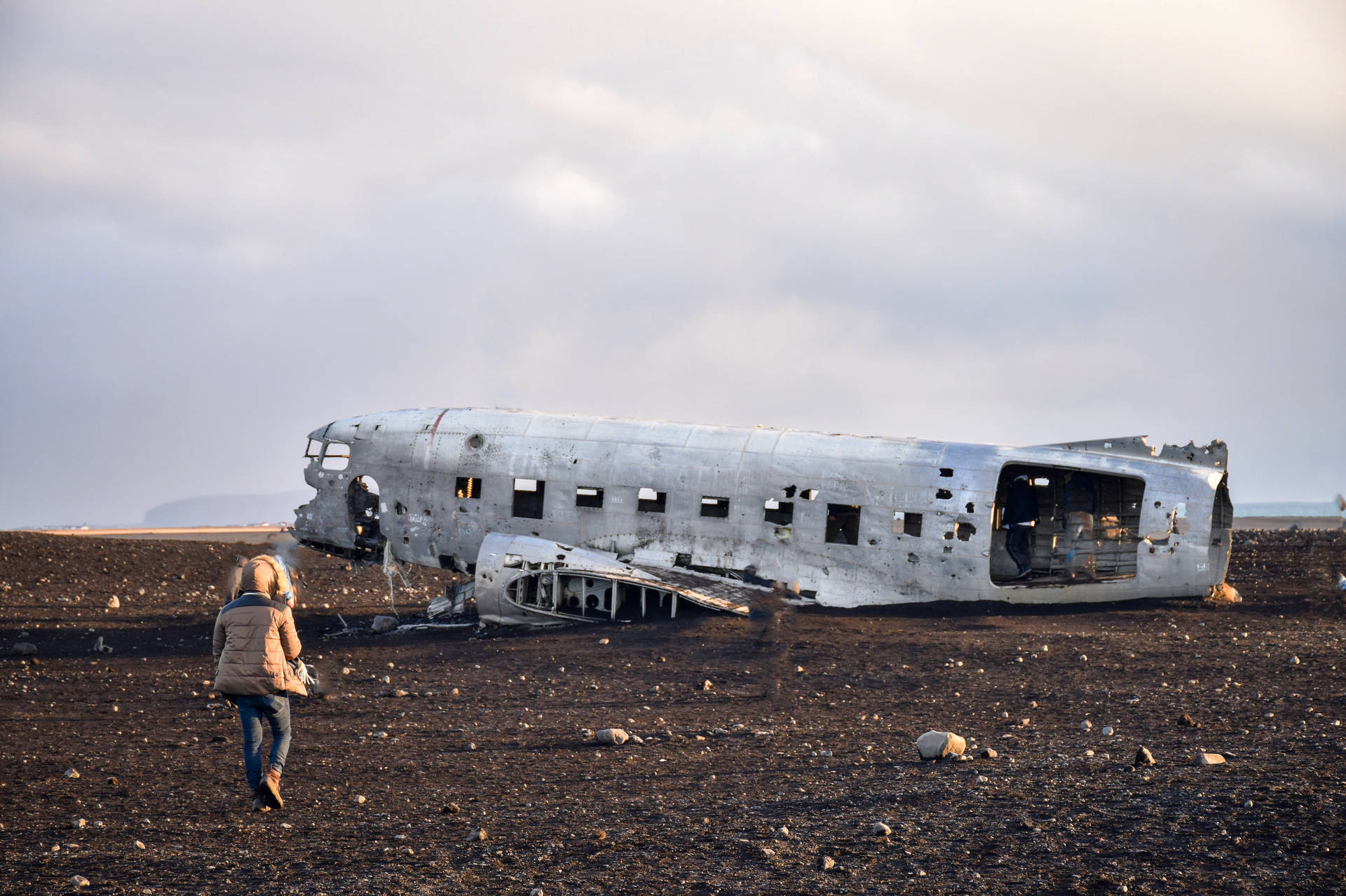 Person Walking To Plane Wreck Background