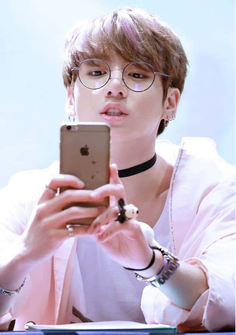 Person With Glasses Using Smartphone Background