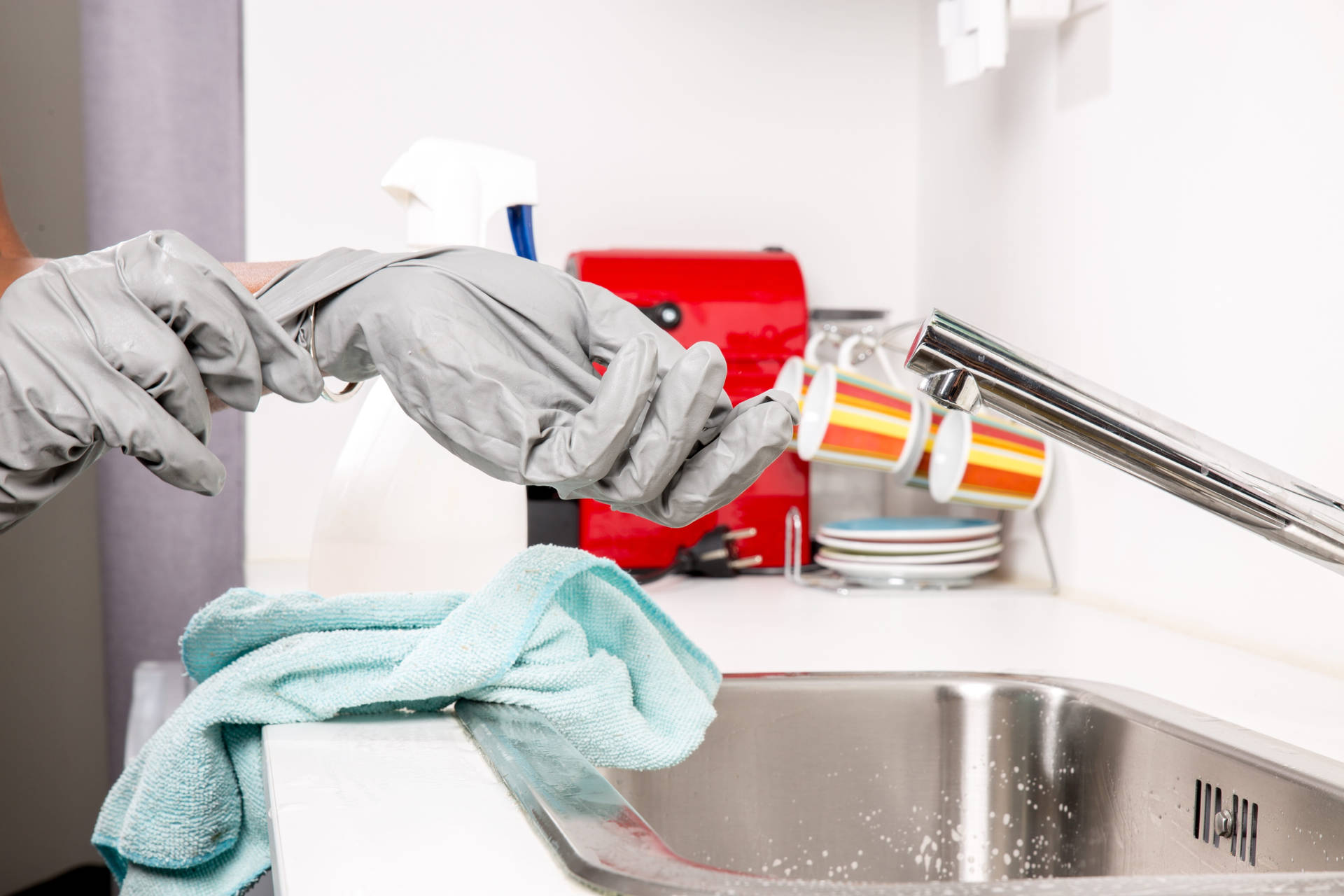 Person With Gray House Cleaning Gloves Background