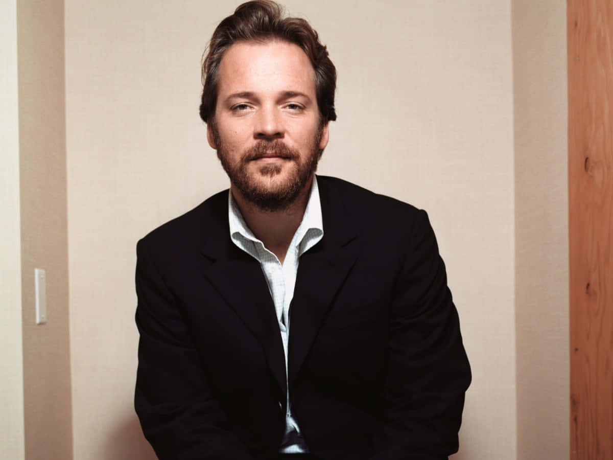 Peter Sarsgaard In A Photoshoot Background
