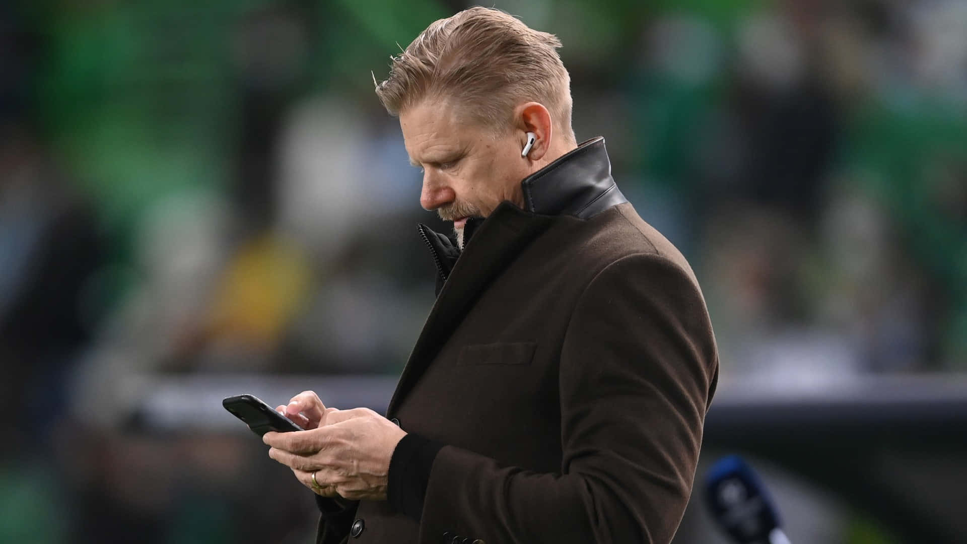 Peter Schmeichel On His Phone Former Football Player Background