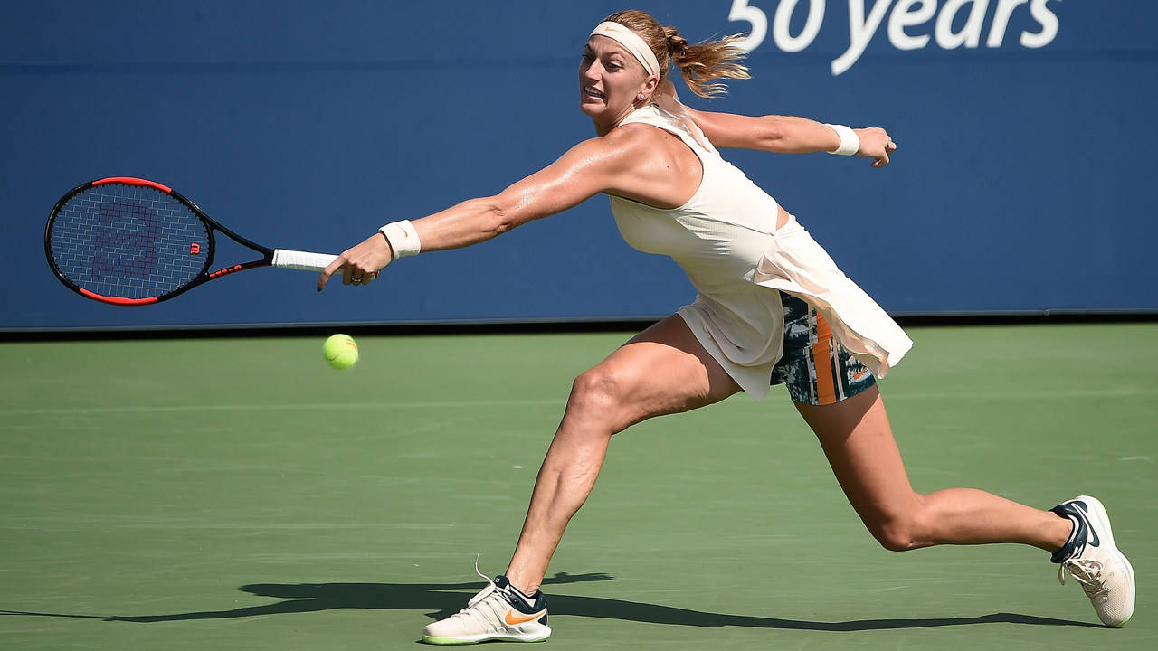 Petra Kvitova Reaching The Tennis Ball Background