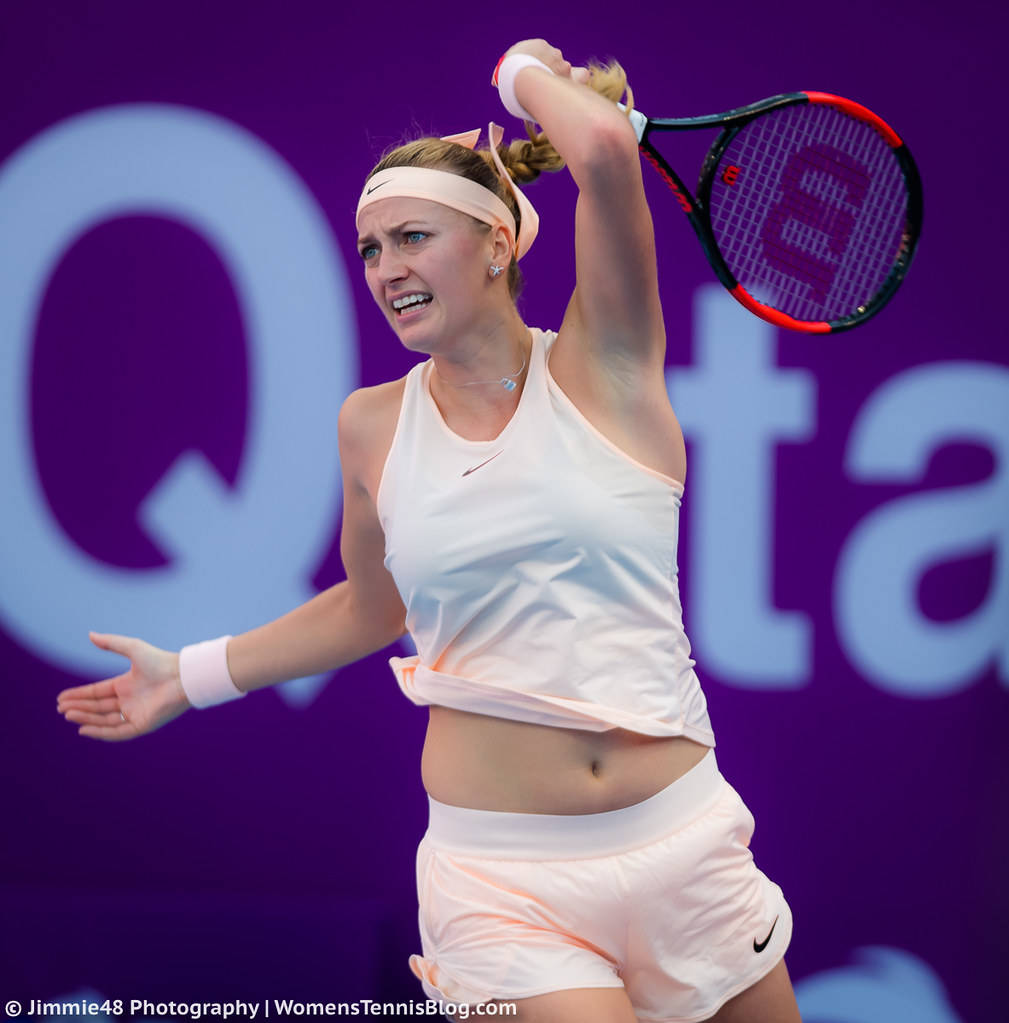 Petra Kvitova Serving On The Tennis Court. Background