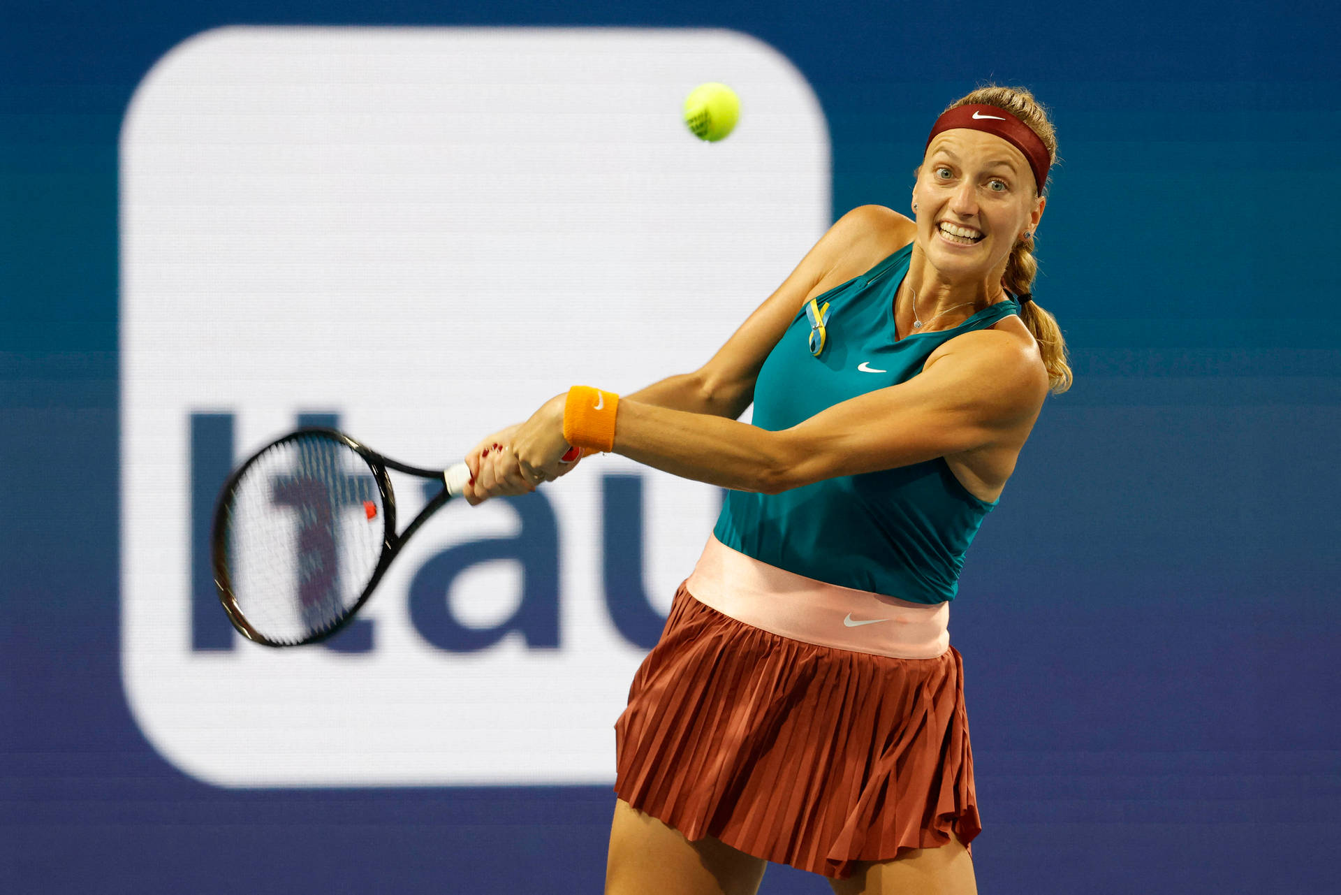 Petra Kvitova Smiling While Hitting Ball Background