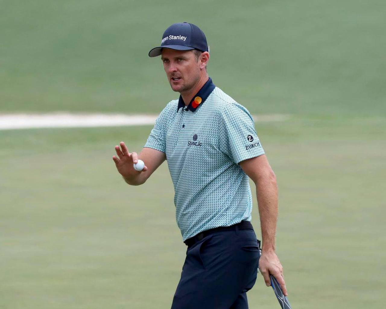 Pga Player Justin Rose Giving Hand Signal On Golf Course