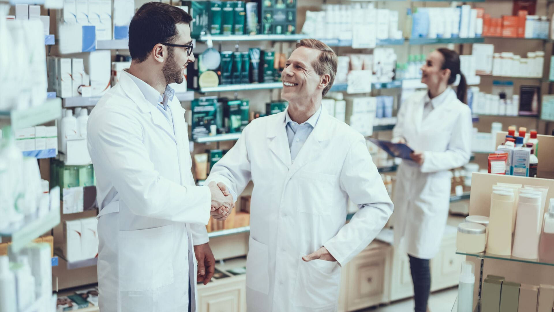 Pharmacists Forming A Professional Connection Through Handshake Background