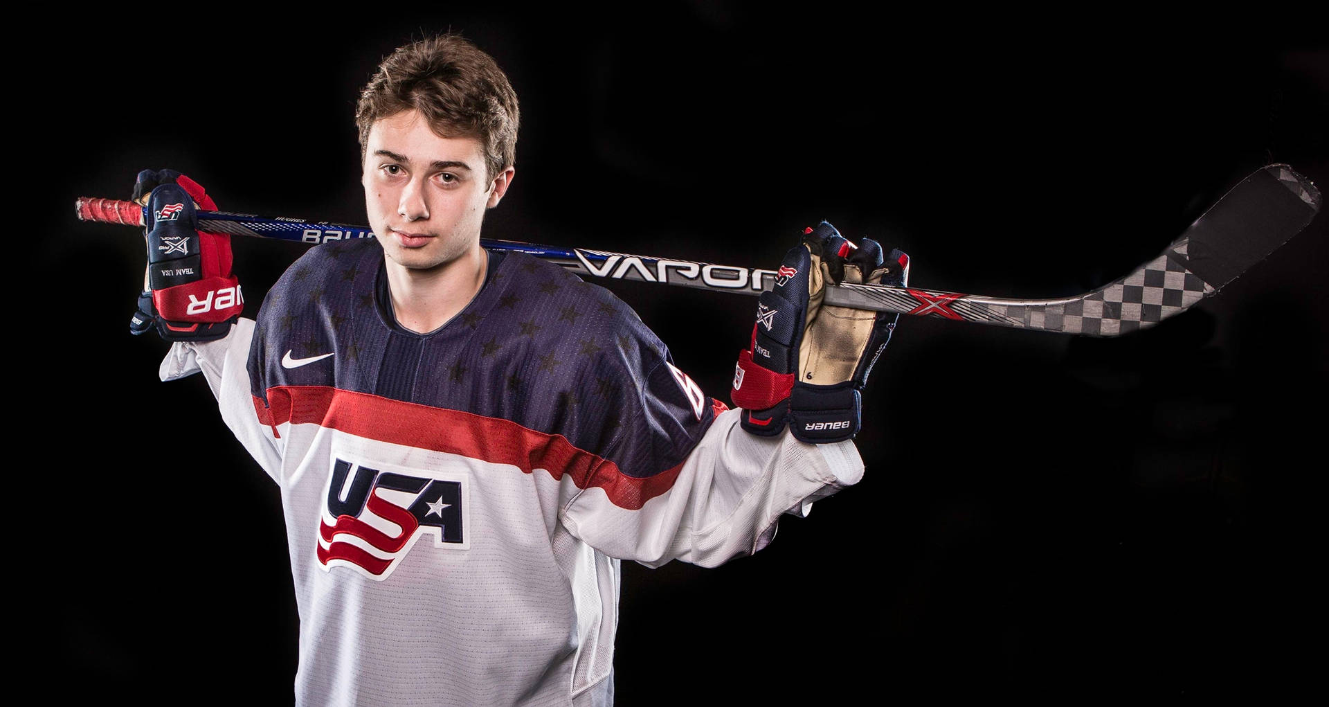 Phenom Quinn Hughes With His Weapon Of Choice Background