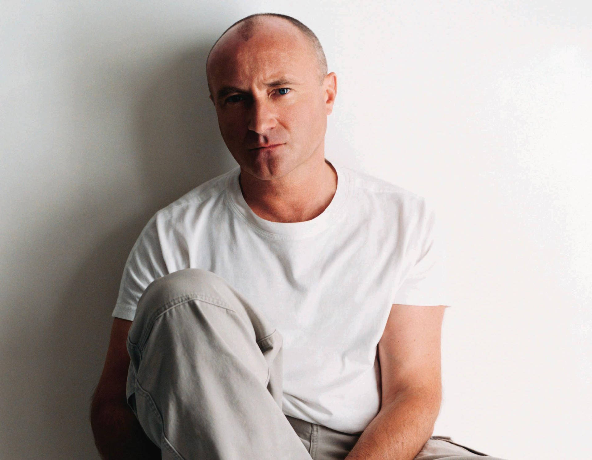 Phil Collins In White Shirt Background