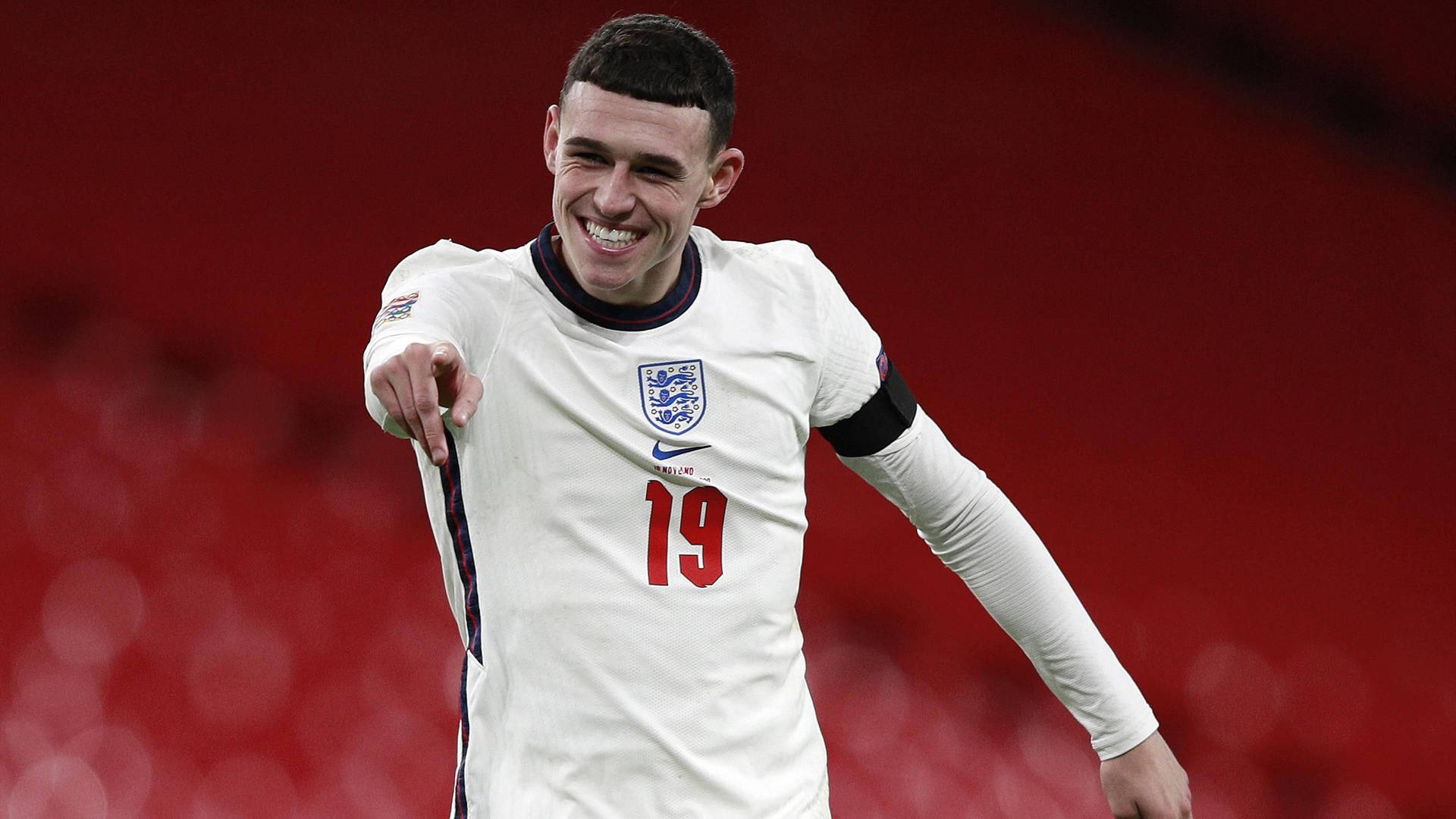 Phil Foden Smiling And Pointing Background